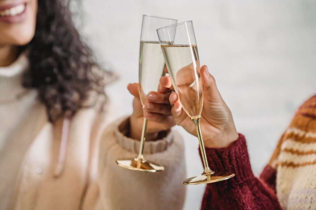 friends clinking glass of champagne while celebrating occasion