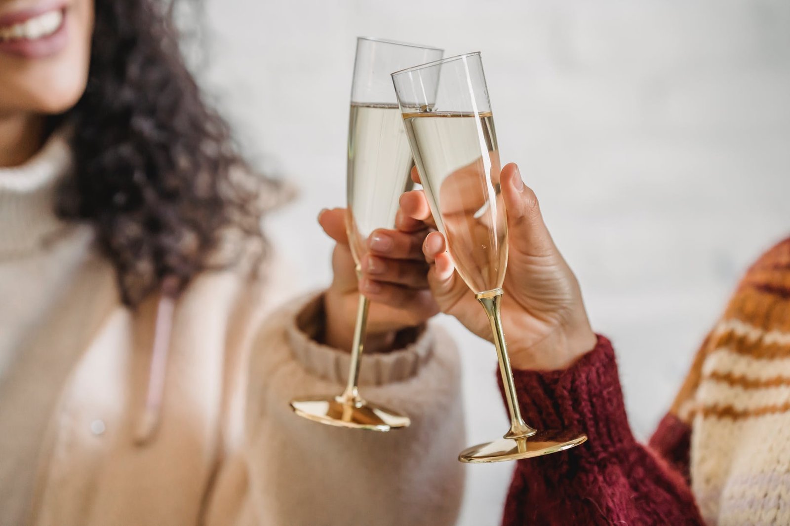 friends clinking glass of champagne while celebrating occasion
